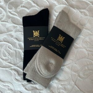 Two pairs of cashmere socks. Sold together. One pair is black, the other taupe.